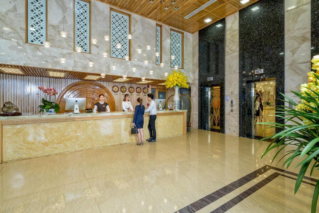 A polished reception lobby with a marble-fronted check-in desk.