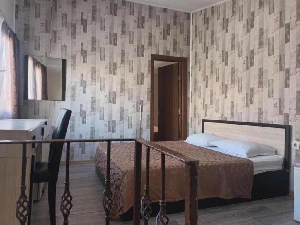 a bedroom with a bed and a table and a desk at Apartments Devora 1 & bar & restaurant in Varna City