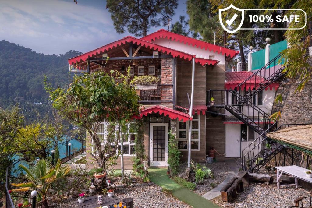 a house with a red roof on a mountain at SaffronStays Farsouli 1° in Bhowāli