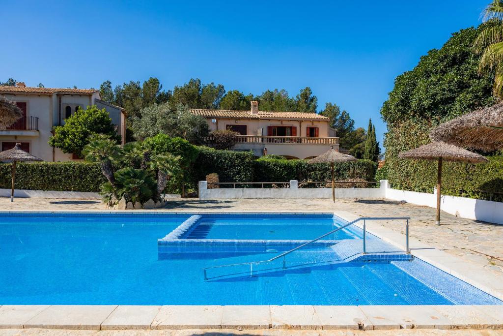 a swimming pool in front of a house at Casa Stevens in Colonia de Sant Pere
