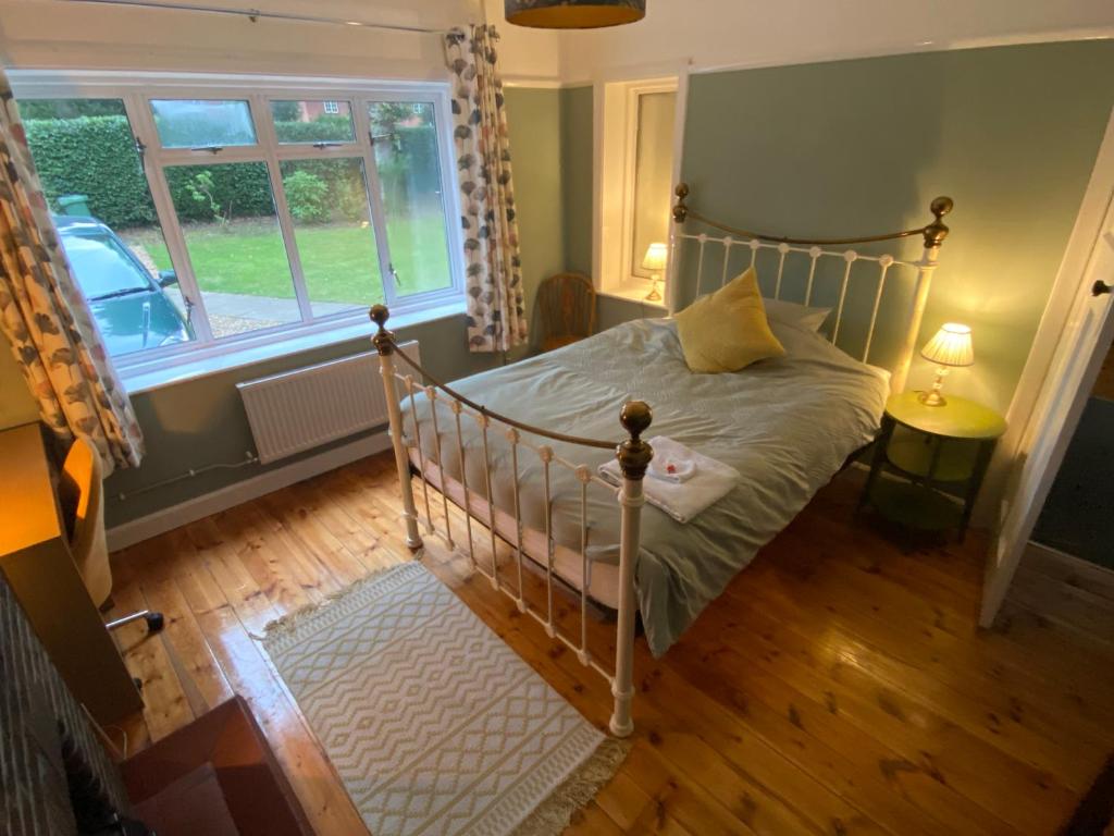 a bedroom with a bed and a window at Double & Single Room Horley near Gatwick in Horley