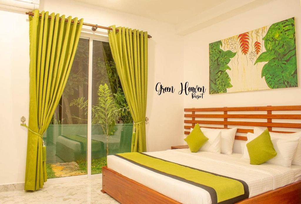 a bedroom with a bed and a window at Green Heaven Resort Kandy in Kandy