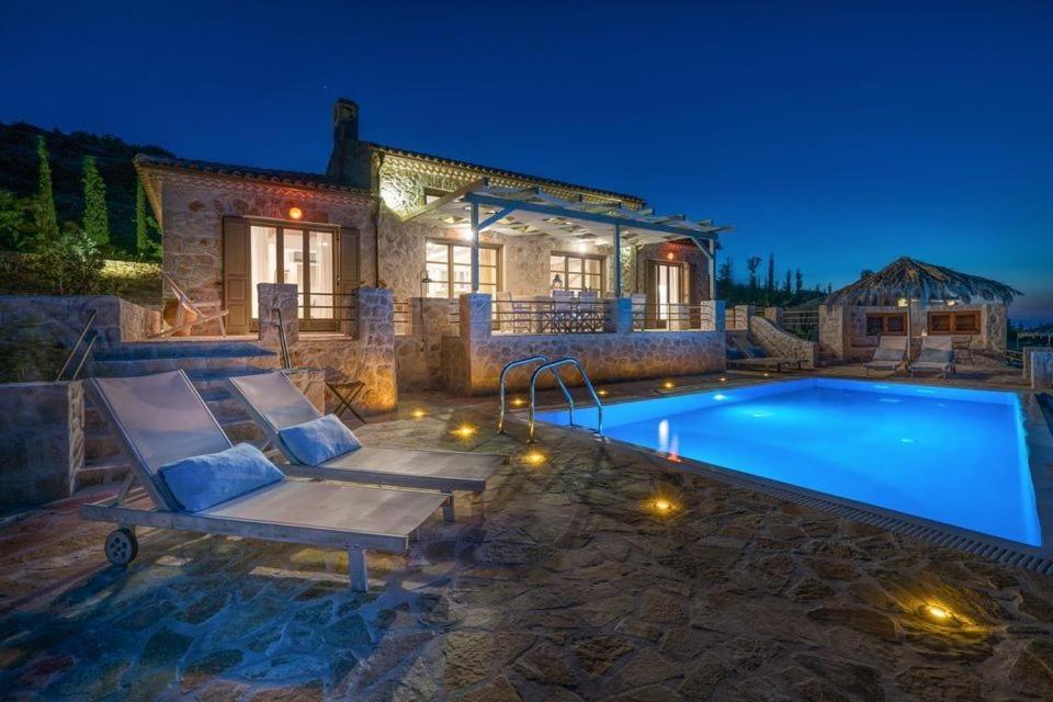 a villa with a swimming pool at night at Extravagant Zante Villa Villa Harmonia Great Sea Views 4 Bedrooms Agios Nikolaos in Koríthion