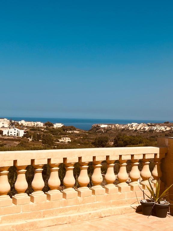 a balcony with a view of the ocean at Narcisa Farmhouse B&B in Nadur