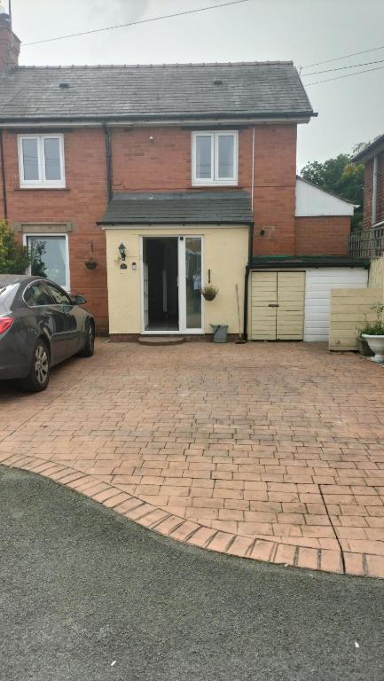 a brick driveway in front of a house at ACCOMADATION WREXHAM in Wrexham
