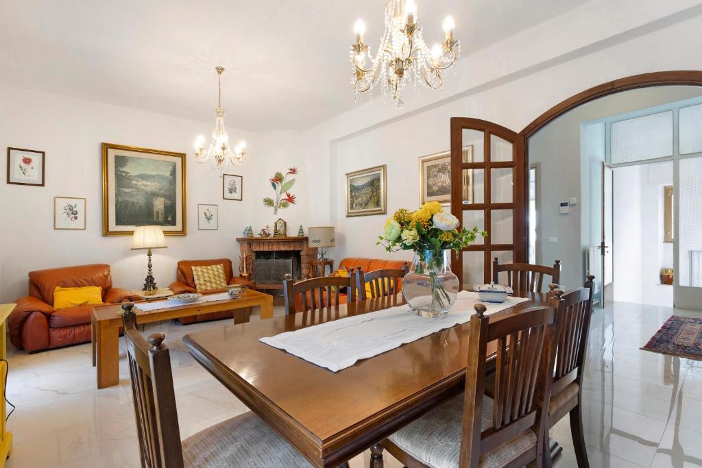 a dining room and living room with a table and chairs at Ca' Lina in Licciana Nardi