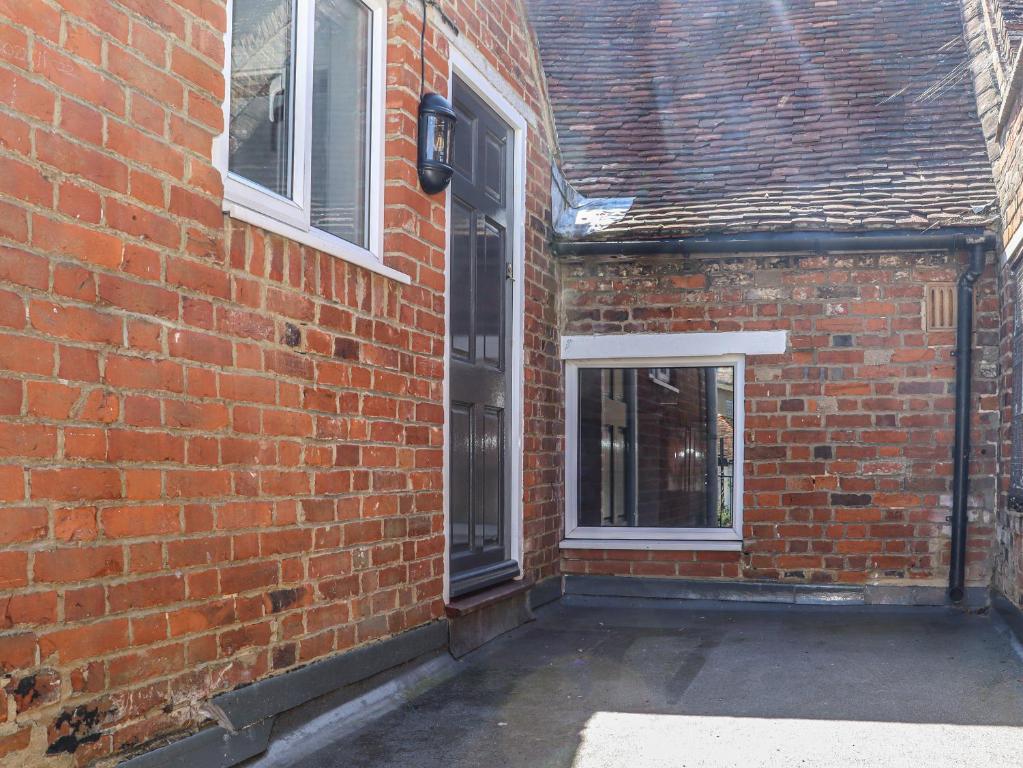 a brick building with a door and a window at The Old Post Office in Canterbury