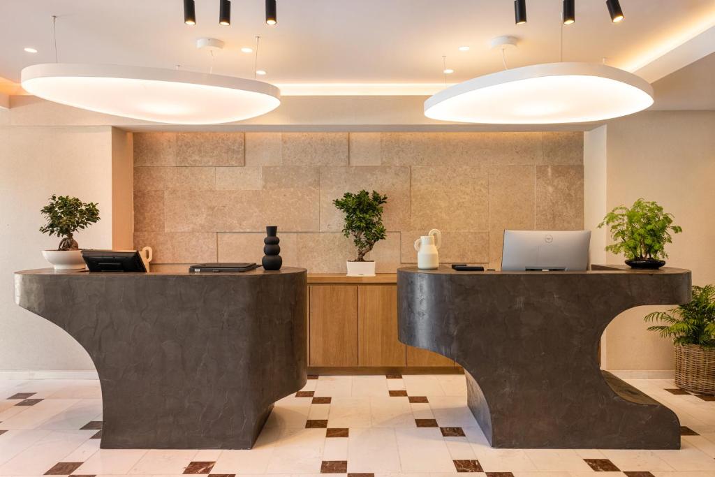 a lobby with a reception desk with a laptop at Erato by Samian Mare in Karlovasi