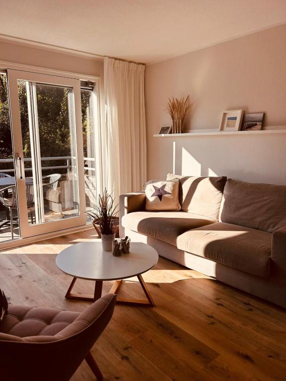 a living room with a couch and a table at Westend Amelander Kaap 85 in Hollum