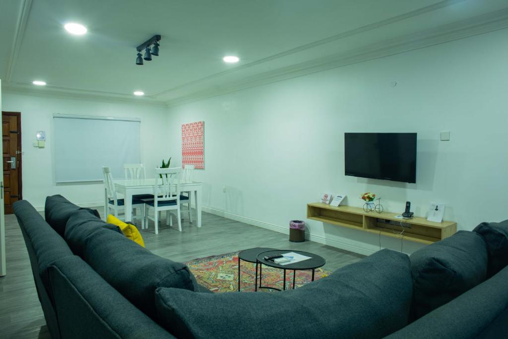 a living room with a couch and a table at Peniel Apartments in Abuja