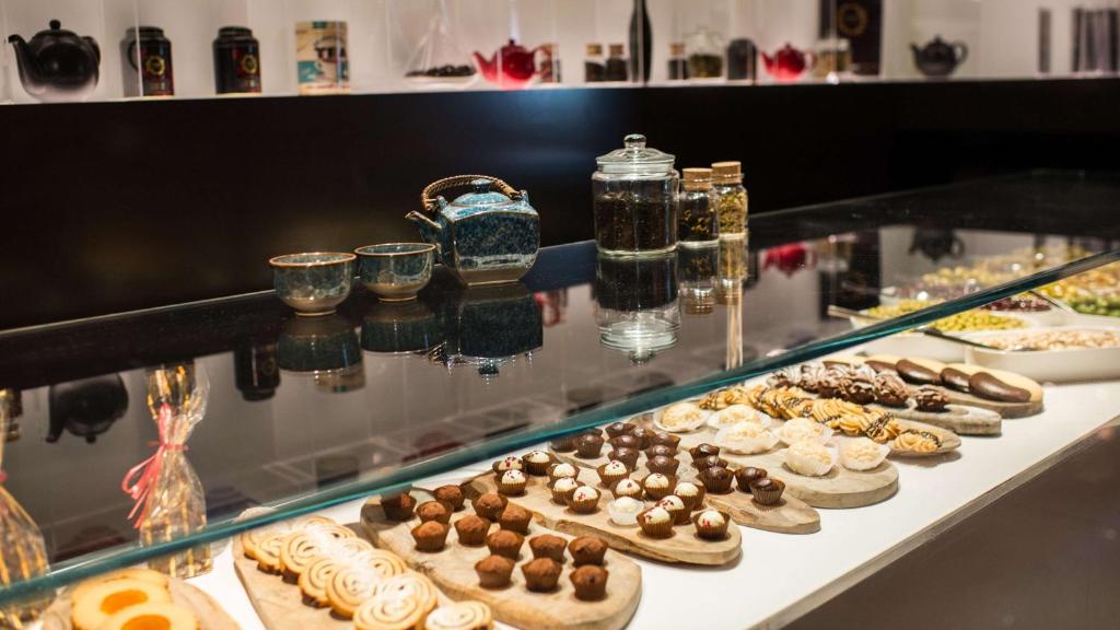 a display case with a bunch of cookies and other desserts at Park Plaza London Westminster Bridge in London