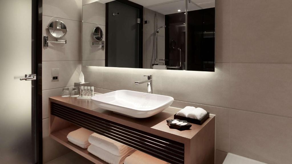 a bathroom with a sink and a mirror at Park Plaza London Westminster Bridge in London