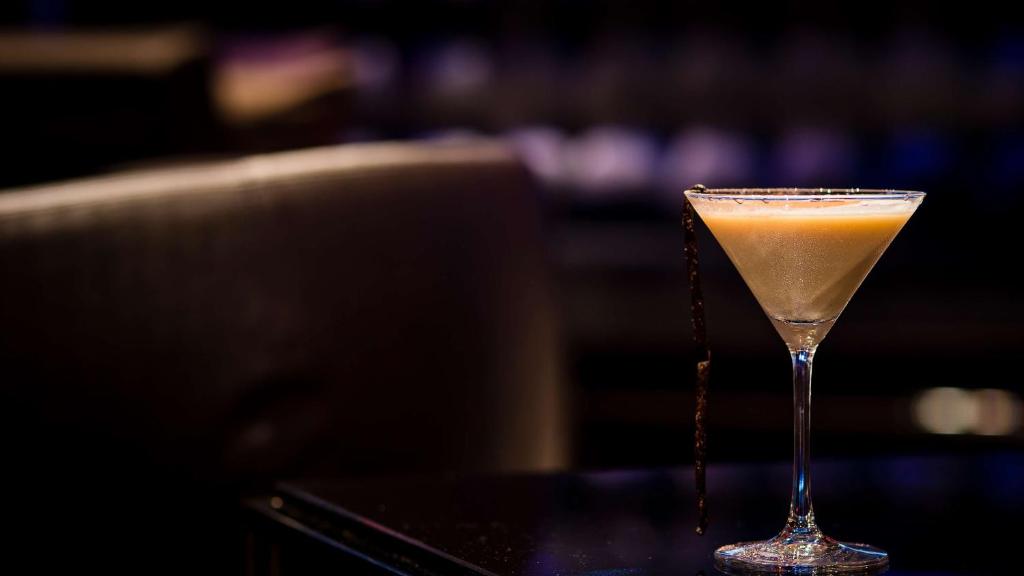 a drink in a martini glass sitting on a table at Park Plaza London Westminster Bridge in London