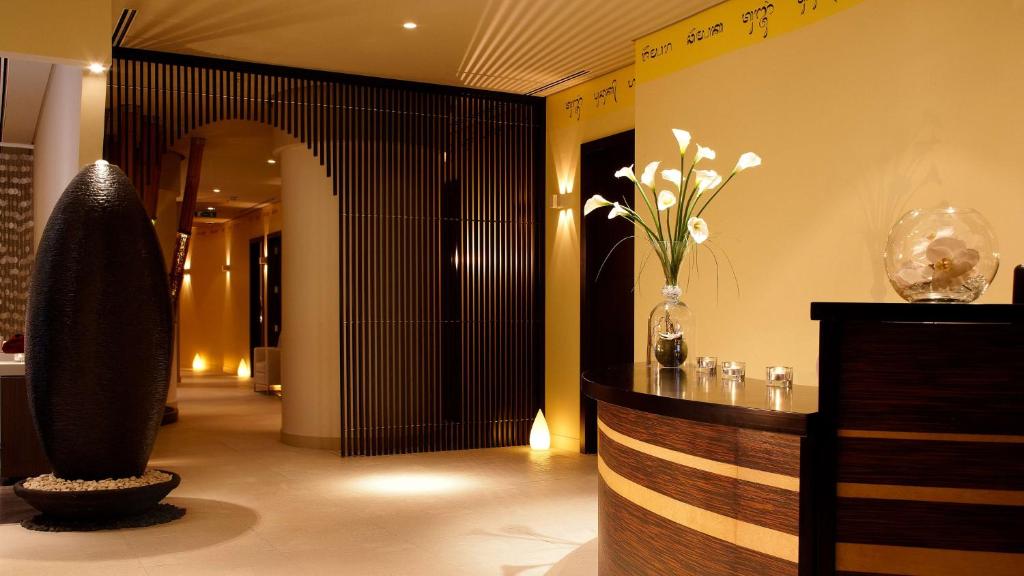a lobby with a vase of flowers and a hallway at Park Plaza London Westminster Bridge in London
