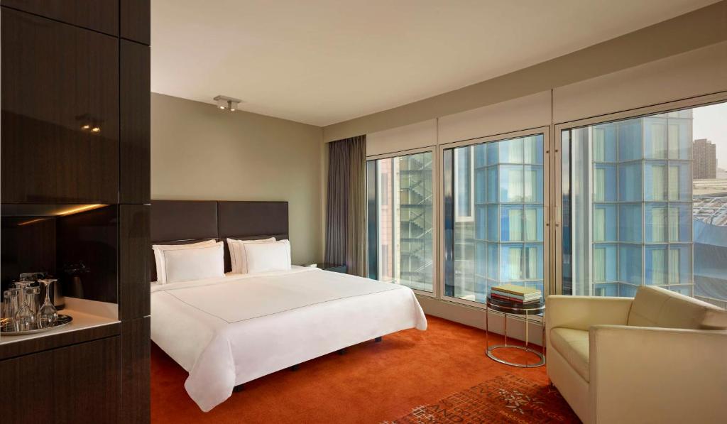a bedroom with a large white bed and a couch at Park Plaza London Westminster Bridge in London