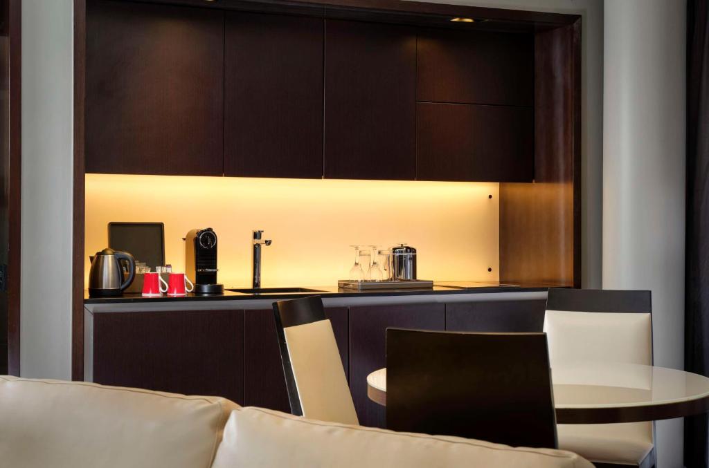 a kitchen with a counter and a table and a counter top at Park Plaza London Westminster Bridge in London