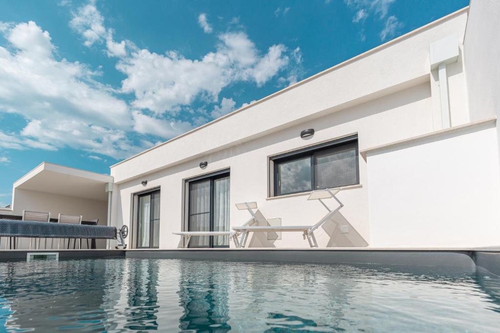 a house with a swimming pool in front of it at Villa Patricia in Santa Barbara