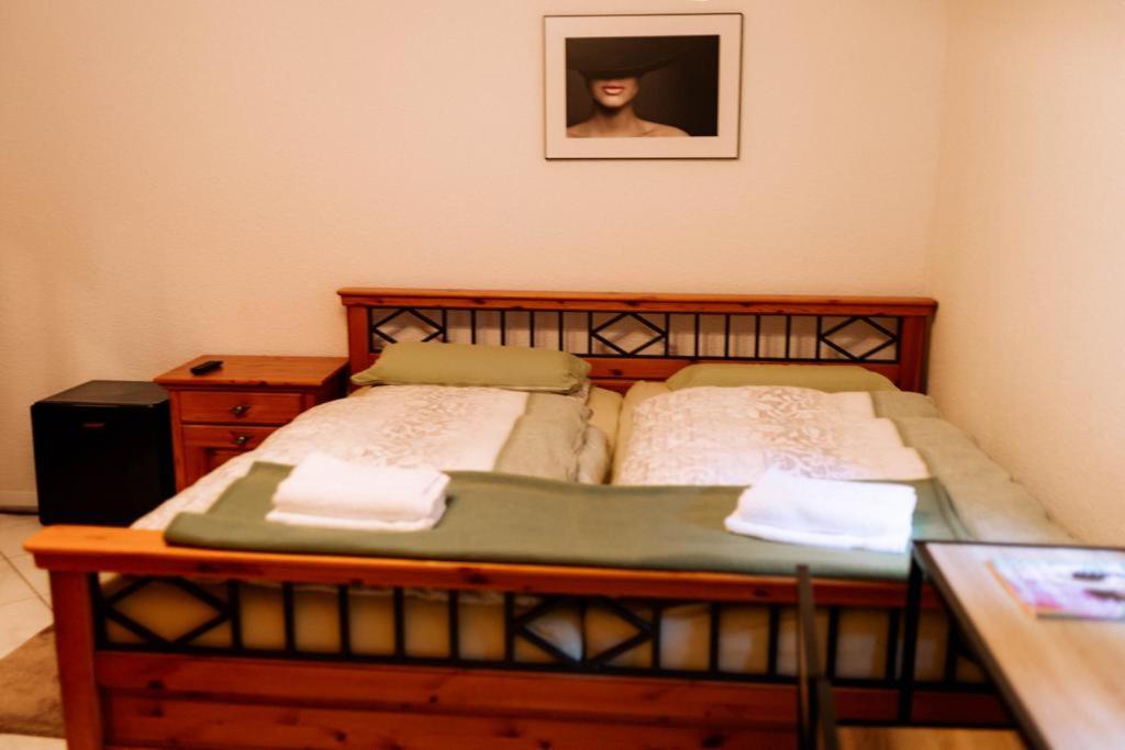 a bedroom with a bed and a table and a picture at Moderne Landwohnung - in Toplage in Gottmadingen