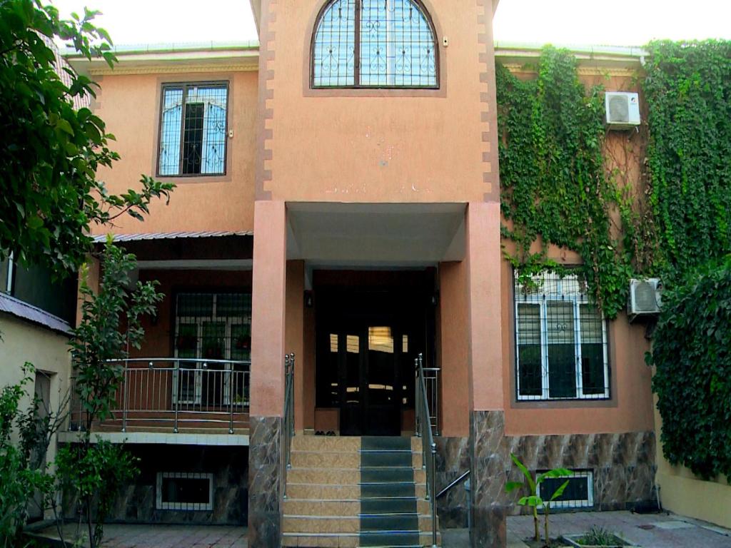 a building with a staircase leading to a door at Orom hostel in Dushanbe