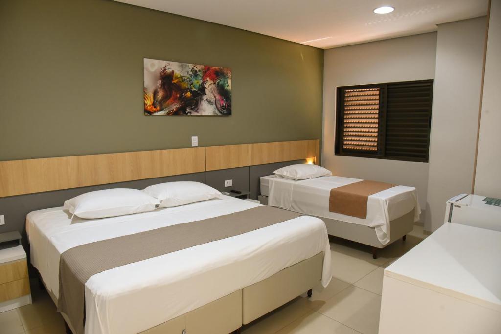 Postel nebo postele na pokoji v ubytování Hotel Plaza Garden