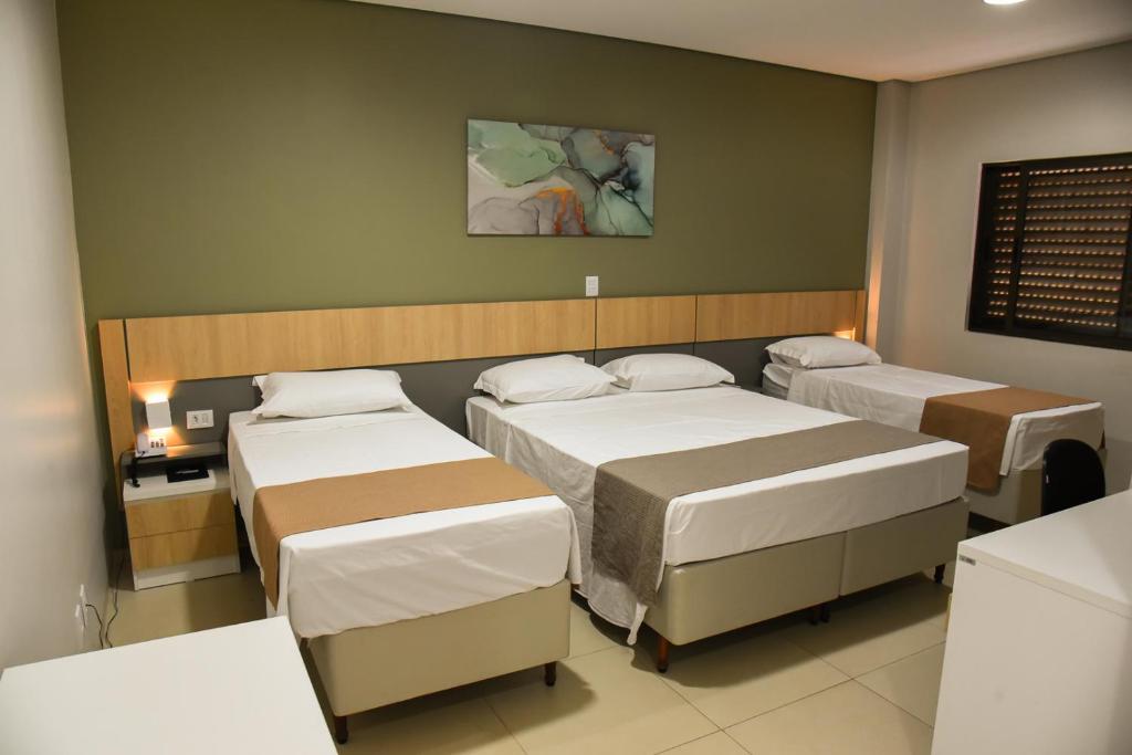 Postel nebo postele na pokoji v ubytování Hotel Plaza Garden