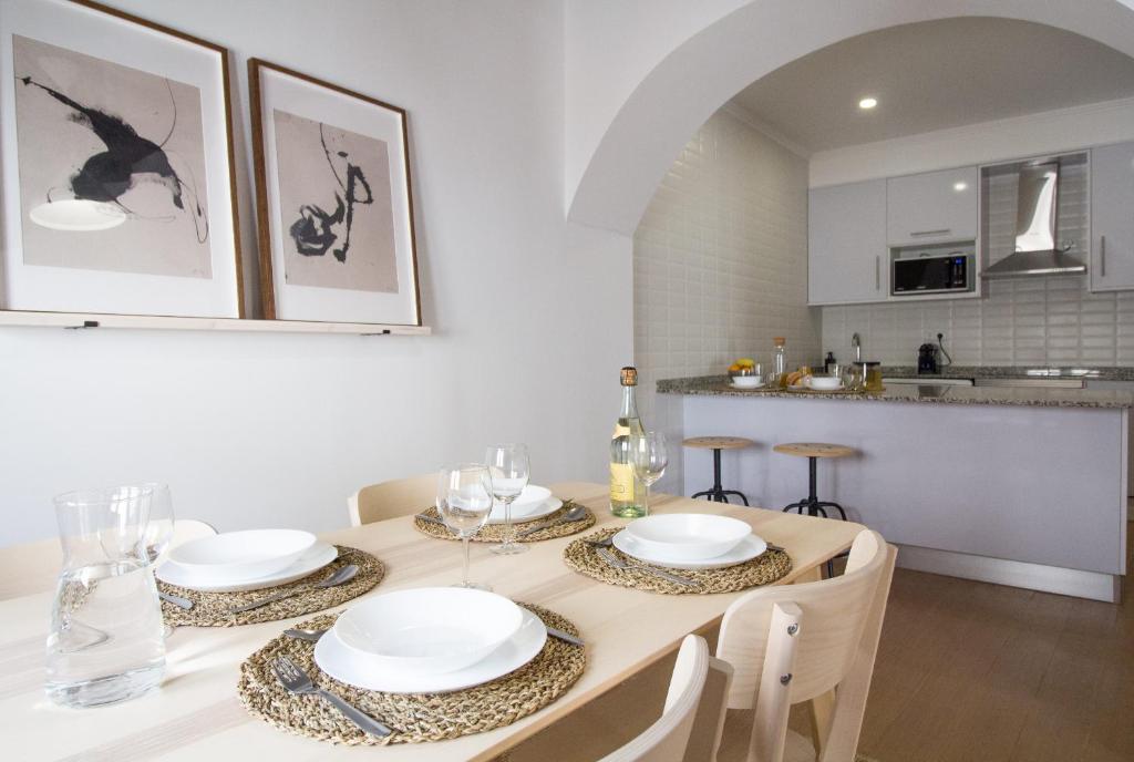 a kitchen and dining room with a table and chairs at Comfortable getaway in Medieval Castro Marim by Lisbeyond in Castro Marim