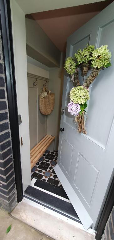 a door with potted plants on top of it at 'The Den' - Malvern - A King Size or Twin Beds plus a Sofa Bed in Great Malvern