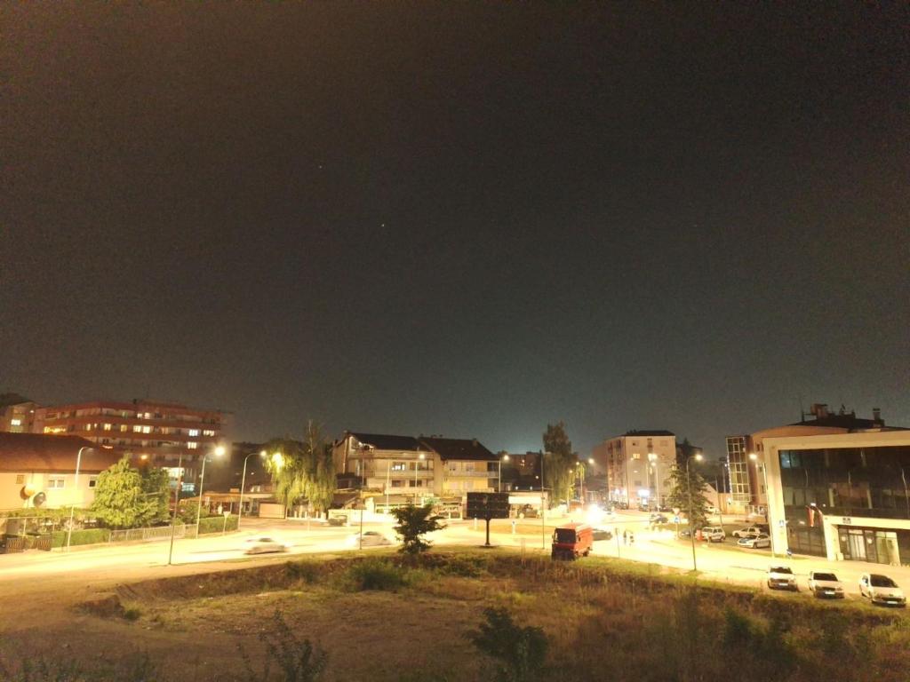 a city at night with cars driving down a street at Elegantna oaza apartment in Banja Luka