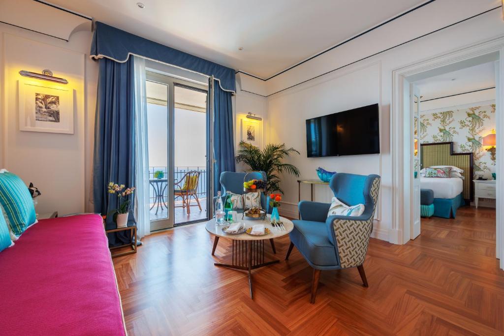 a living room with a couch and a table at Grand Hotel San Pietro Taormina in Taormina