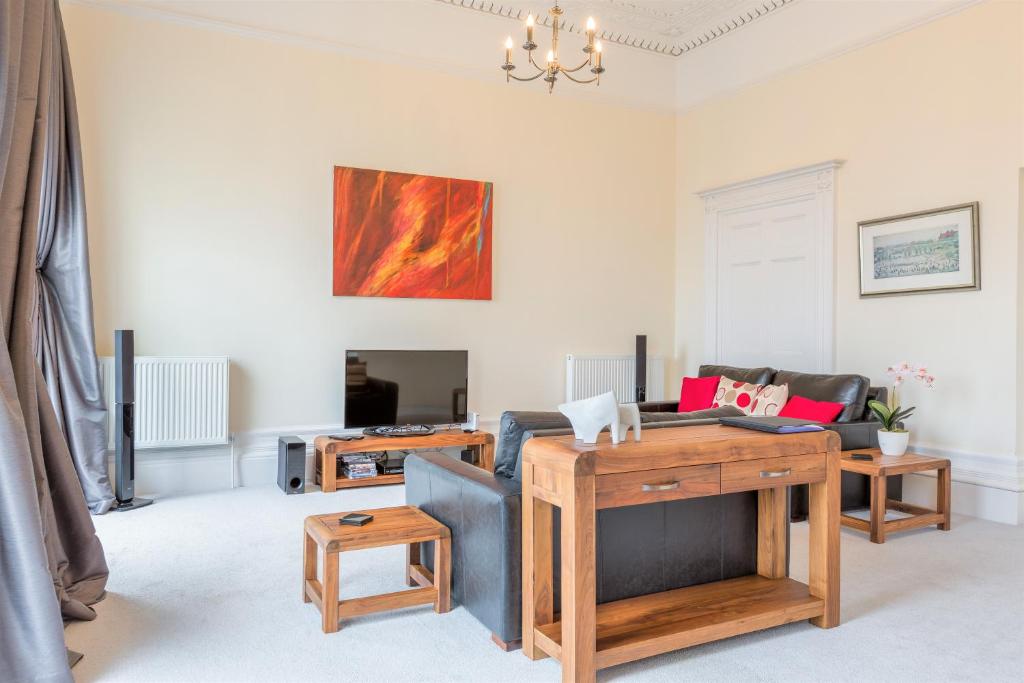 a living room with a couch and a table at Croft House - By Luxury Apartments in Cheltenham