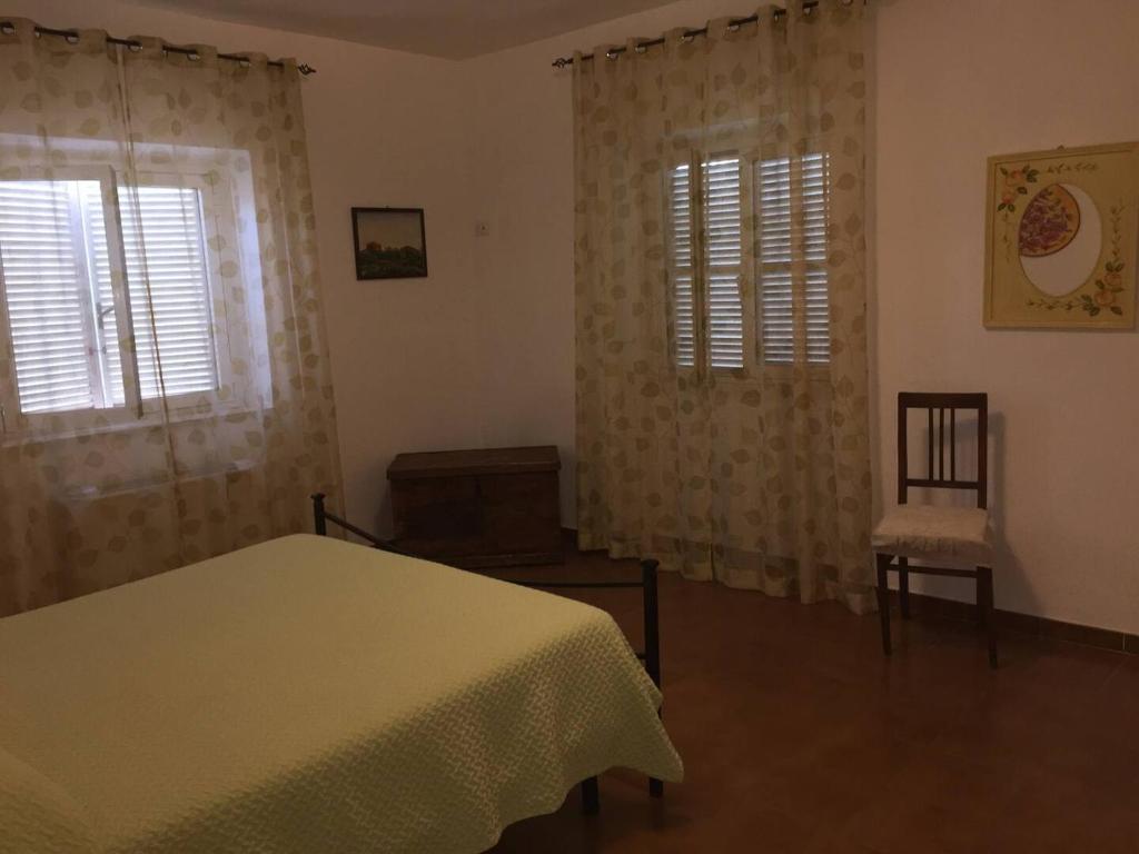 A bed or beds in a room at Casale Gli Ulivi