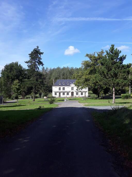 a large white house sitting on top of a road at L&#39;Atelier à l&#39;orée des bois in Saint-Pierre-sur-Dives