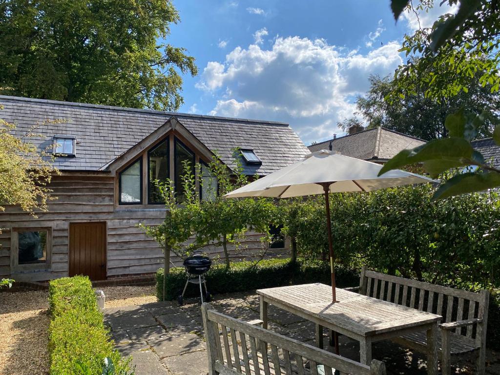 a table with an umbrella in front of a house at Avon Turn View in Salisbury