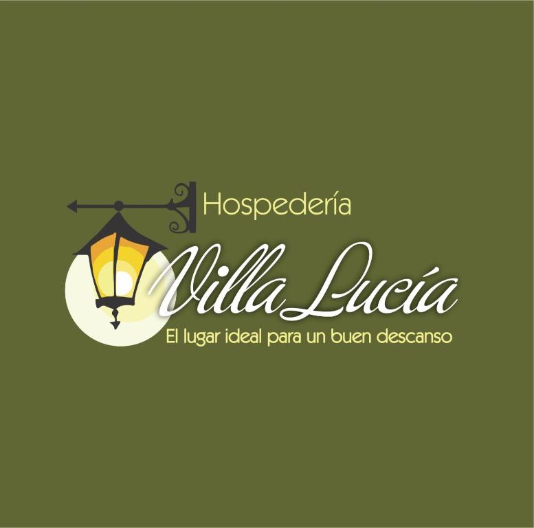 a sign for a hotel with a lighted lamp and the words milka l at Hospedería Villa Lucía in Villa de Leyva