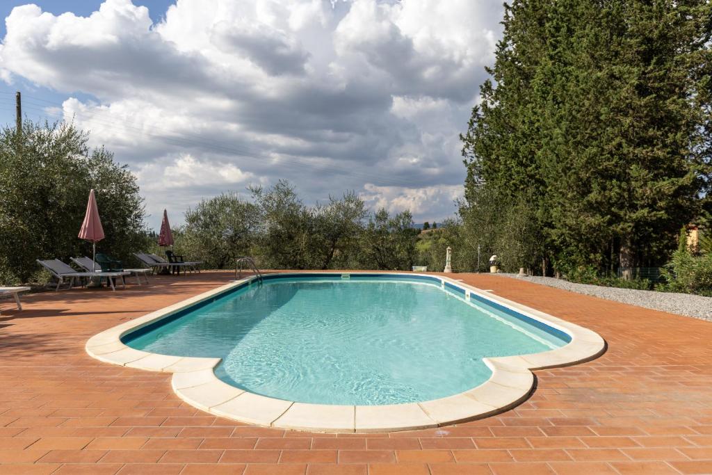 a large swimming pool on a brick patio at Martignana in Empoli