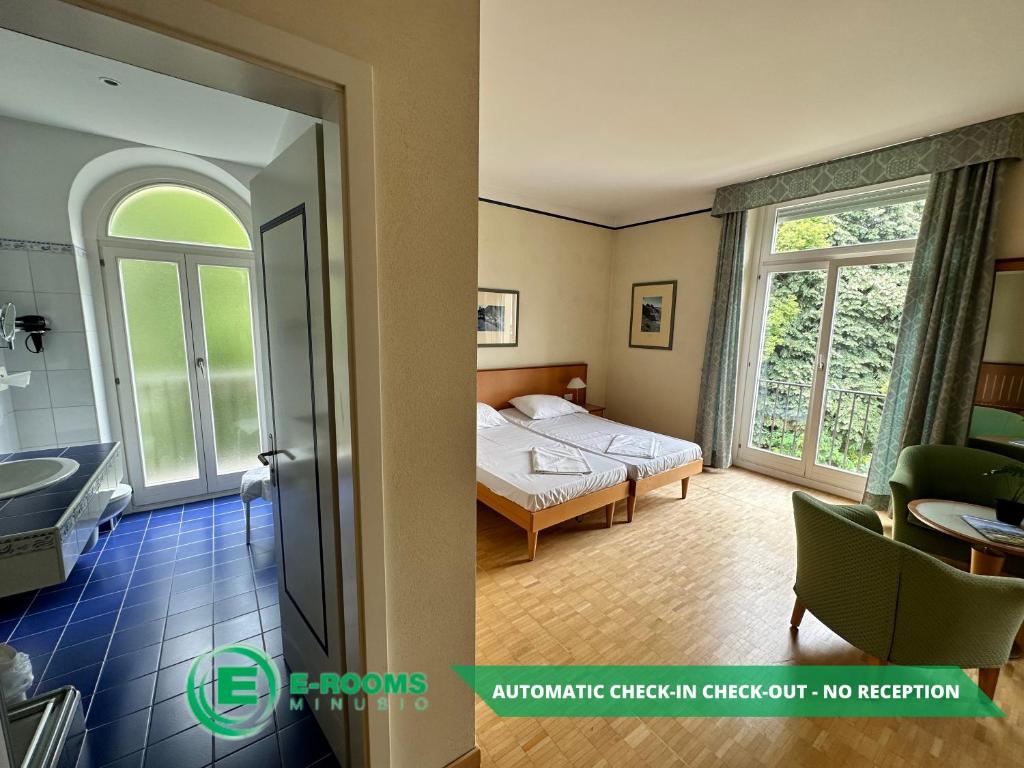 Postel nebo postele na pokoji v ubytování E-Rooms Minusio