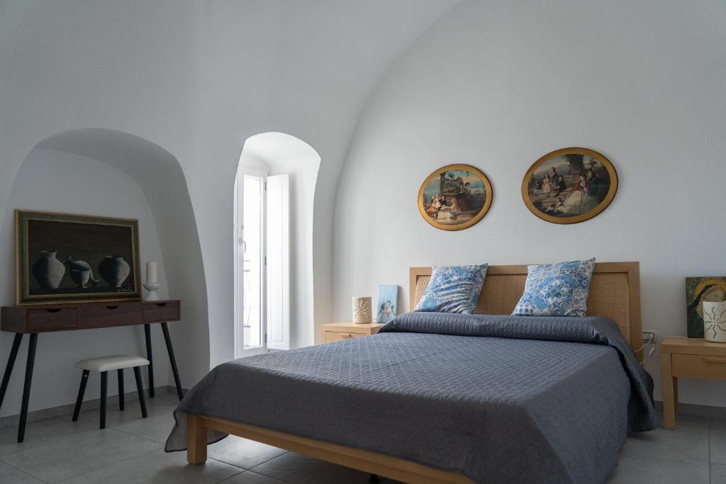 a bedroom with a bed and two plates on the wall at La Corte di Navarrete in Laterza