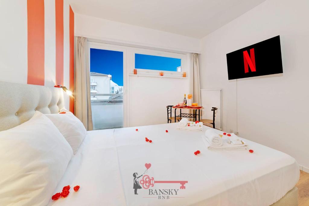 a bedroom with a white bed with roses on it at Coral 5 for 2 Pax City Wi-Fi Free -By EasyLife Swiss in Lugano