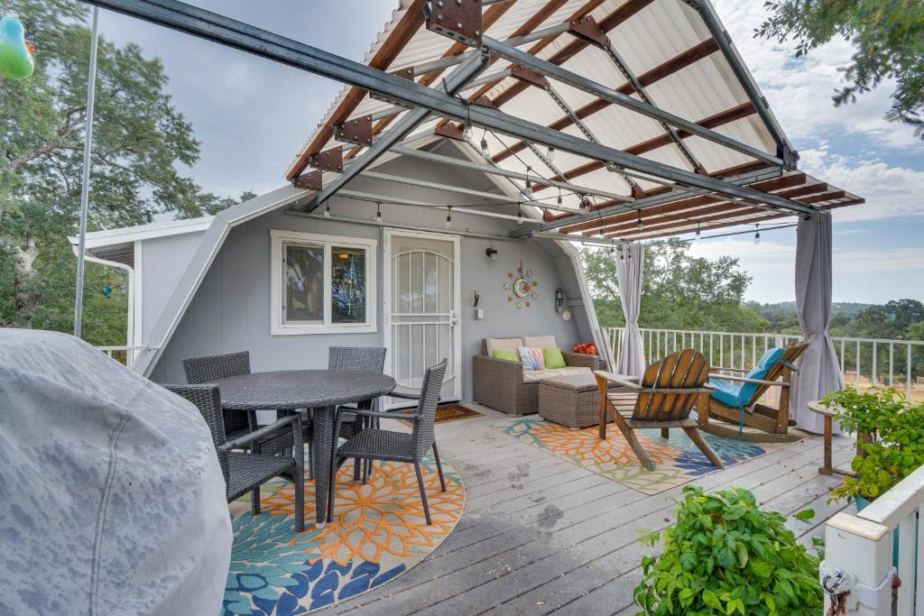 a patio with a table and chairs on a deck at Mariposa Home Furnished Patio and Sierra Mtn Views in Mariposa