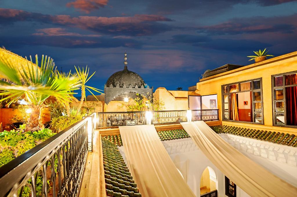 a view from the balcony of a building at night at Riad Dar Nadwa in Marrakesh