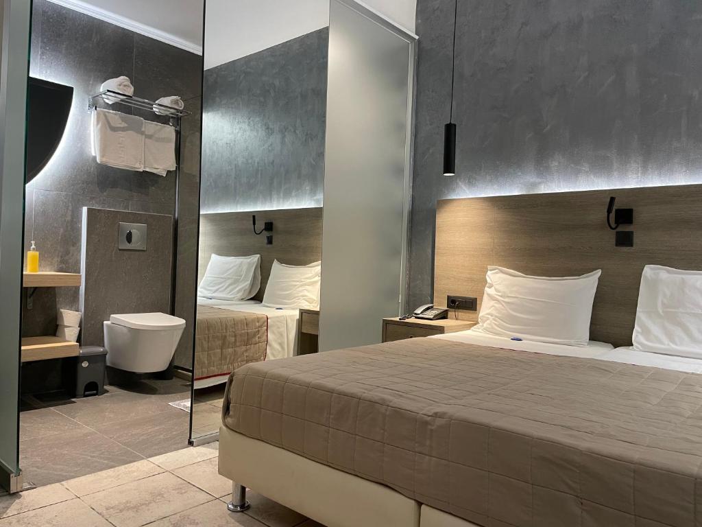 Postel nebo postele na pokoji v ubytování Voula Hotel