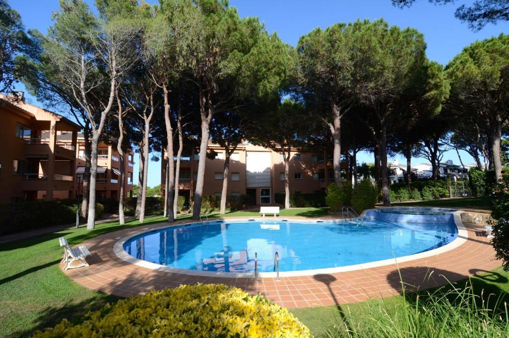 a swimming pool in a yard with trees at Puig sa Guilla 1C B3 in Pals