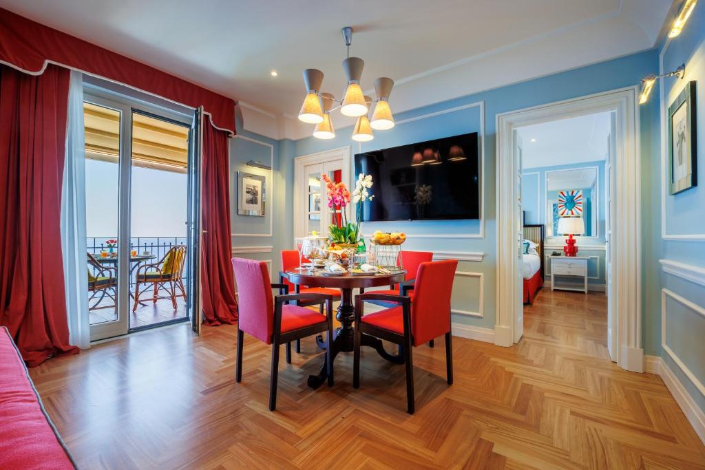 a dining room with a table and red chairs at Grand Hotel San Pietro Taormina in Taormina