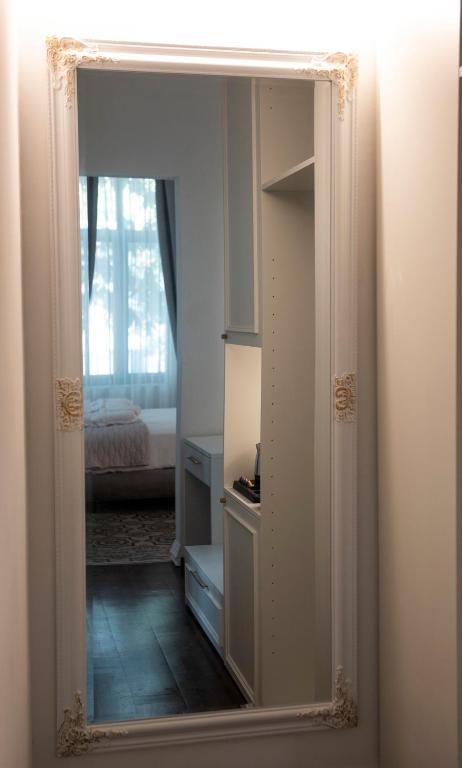 a mirror in a room with a bedroom at Jensen Luxury Suites in Rhodes Town