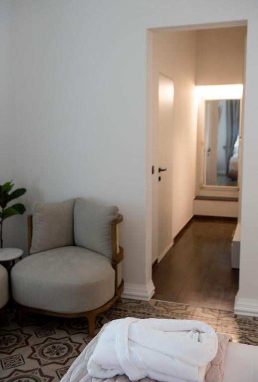 a living room with a couch and a chair at Jensen Luxury Suites in Rhodes Town