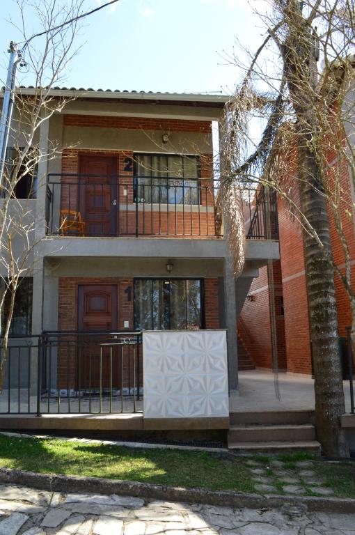 a large house with a balcony and a porch at Chalés Estrada Real in Conceição da Ibitipoca