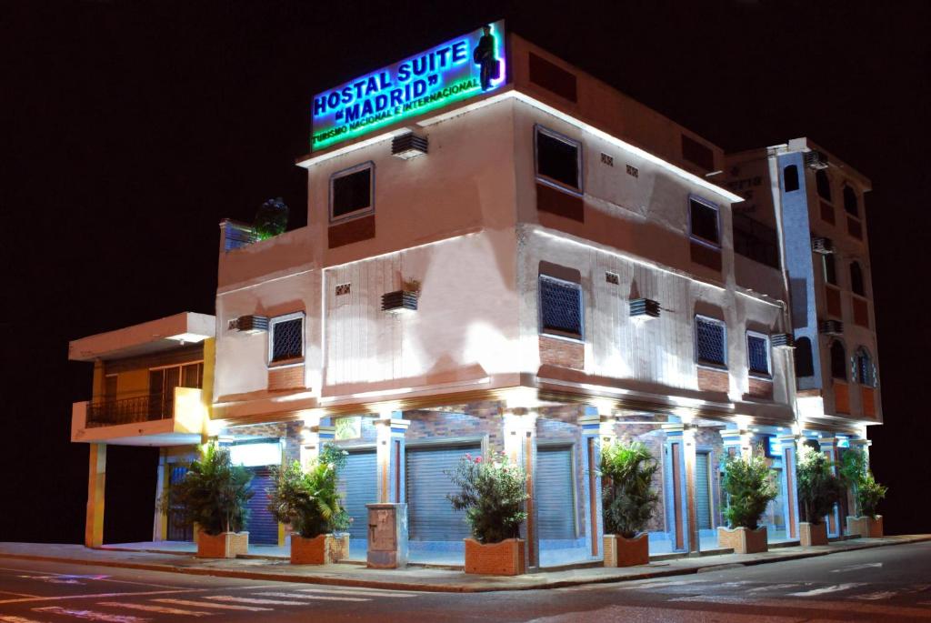 un edificio con un cartel en el costado en Hostal Suites Madrid, en Guayaquil