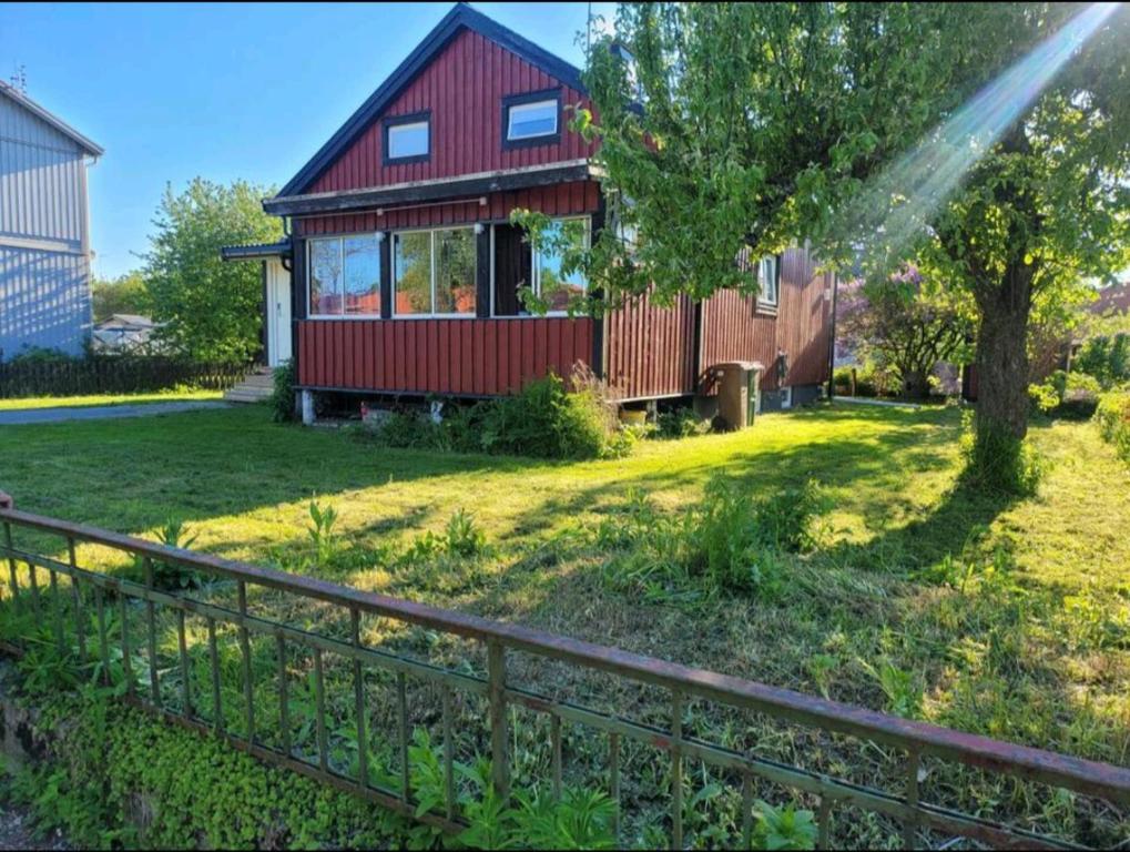 a red house with a fence in front of it at Remarkable 1-Bed Apartment in Orebro in Örebro