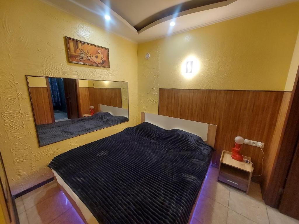 a bedroom with a bed and a large mirror at Arnautskaya apartments in Odesa