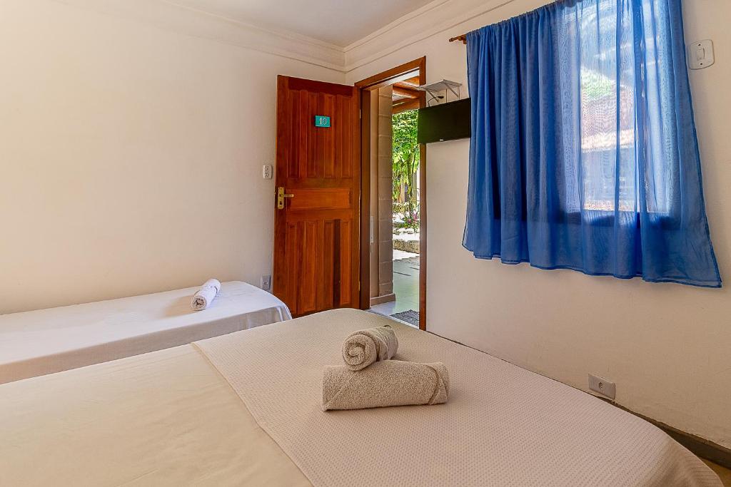 Postel nebo postele na pokoji v ubytování Na Casa 11 - Pousada e Hostel